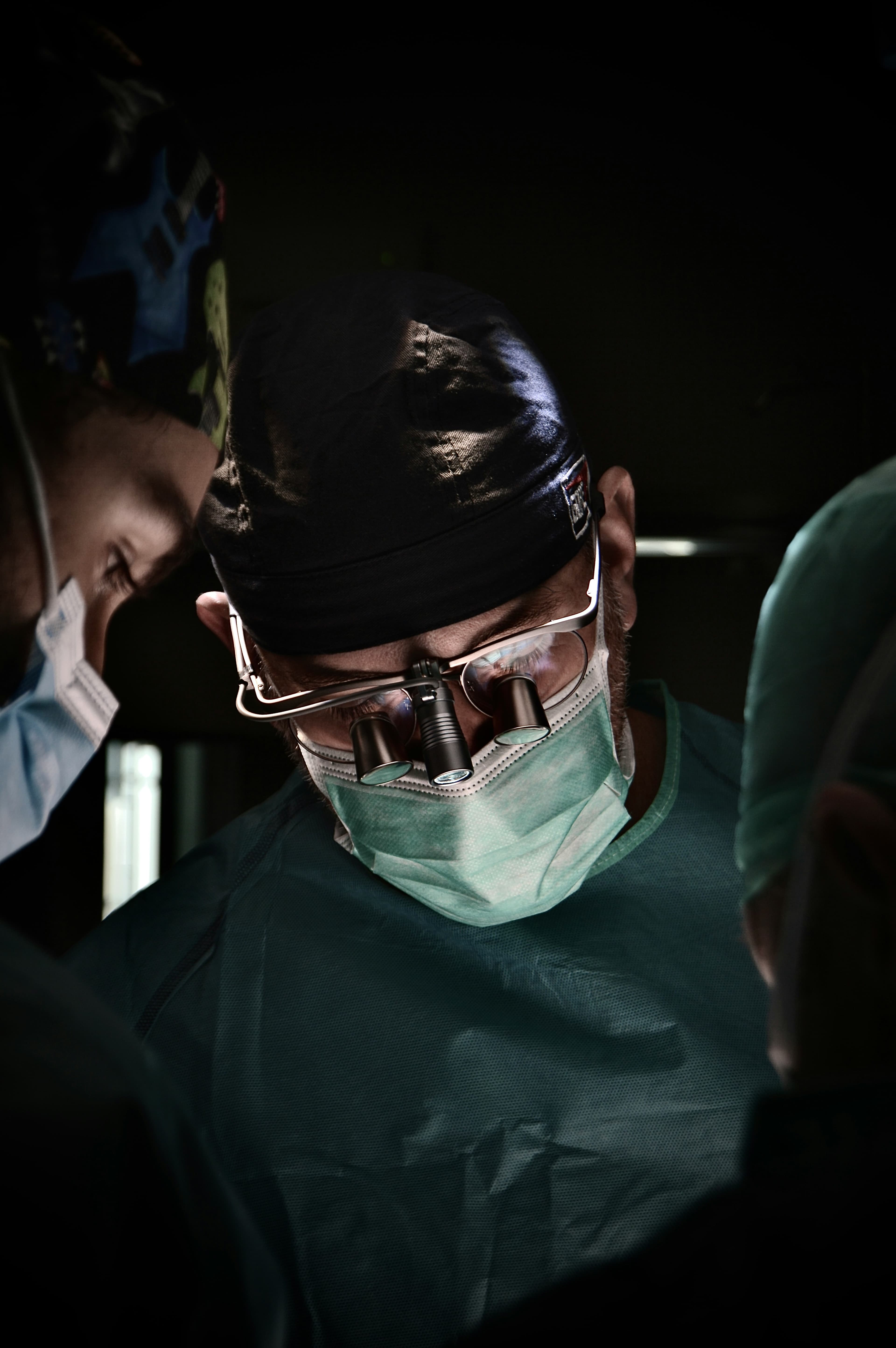 Dental surgeon with loupes performing precise procedure